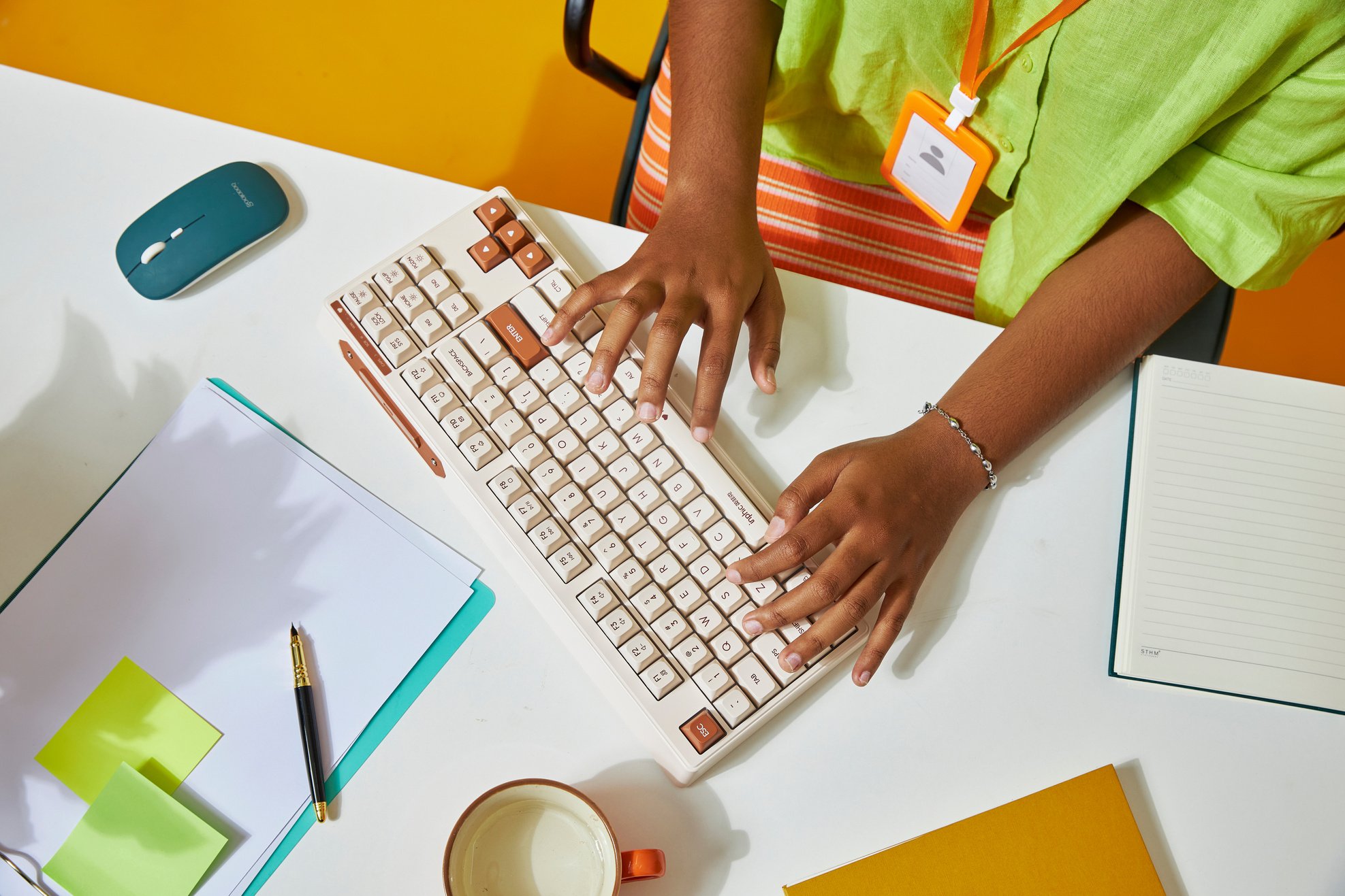 Woman Typing in Bright Yellow Office